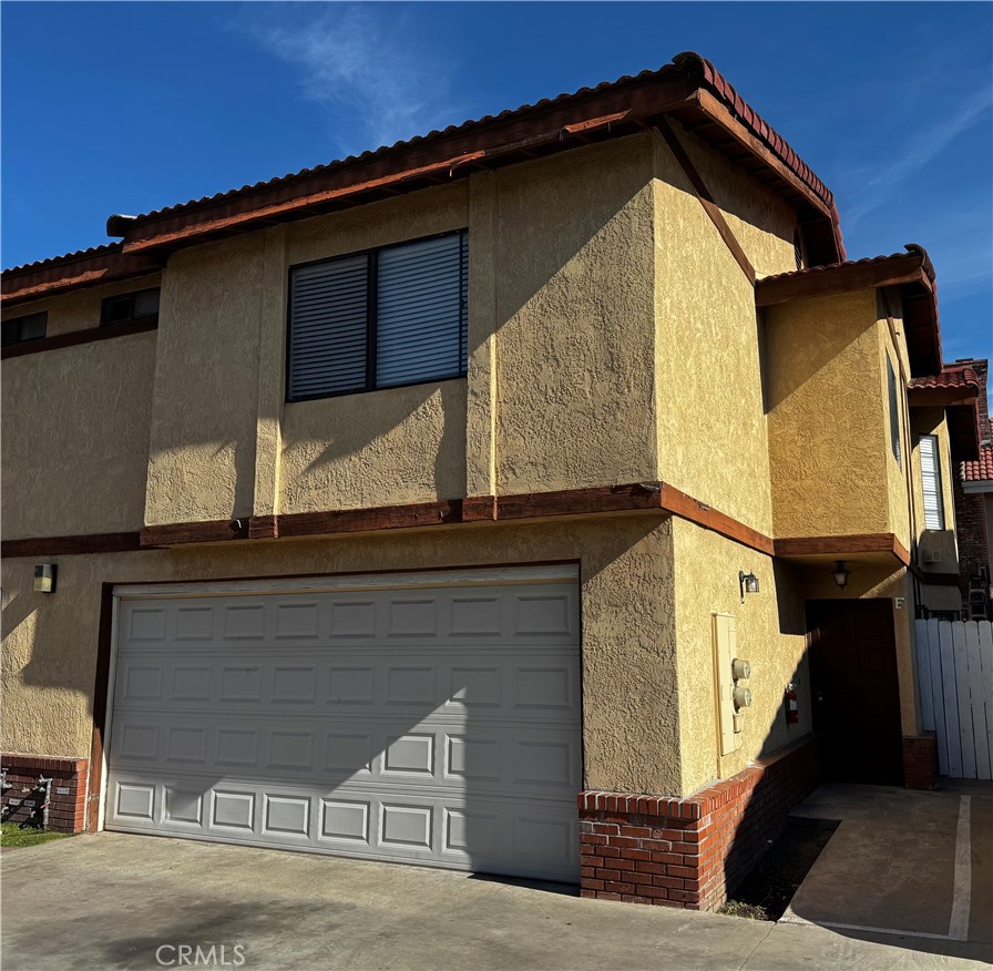 3930 Maxson, Unit F El Monte, CA 91732 - Photo 1 of 14 a front view of a house with a garage