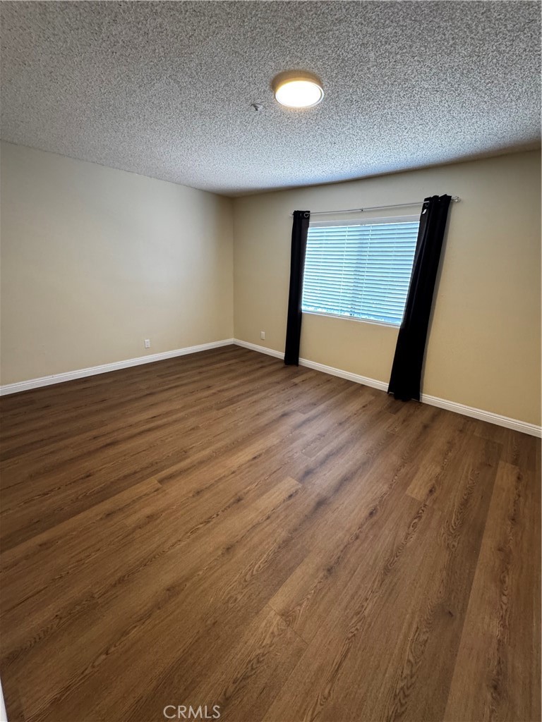 3930 Maxson, Unit F El Monte, CA 91732 - Photo 12 of 14 a view of an empty room with wooden floor and a window