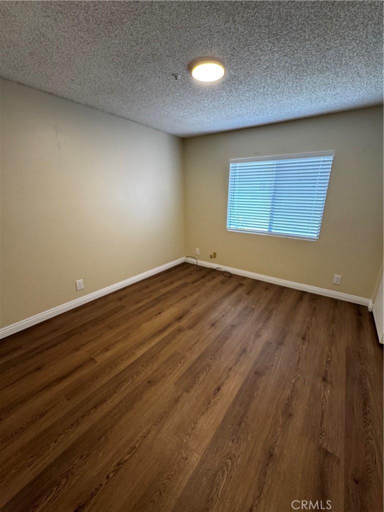 3930 Maxson, Unit F El Monte, CA 91732 - Photo 13 of 14 a view of an empty room with wooden floor and a window