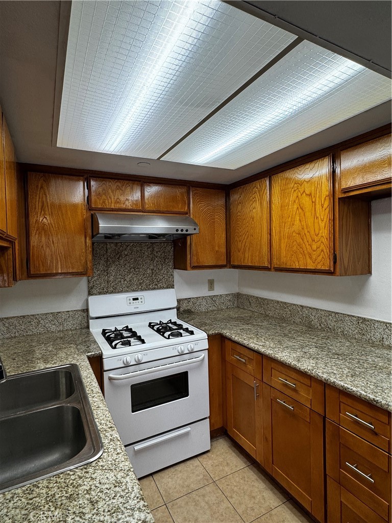 3930 Maxson, Unit F El Monte, CA 91732 - Photo 4 of 14 a kitchen with granite countertop stainless steel appliances a stove sink and cabinets