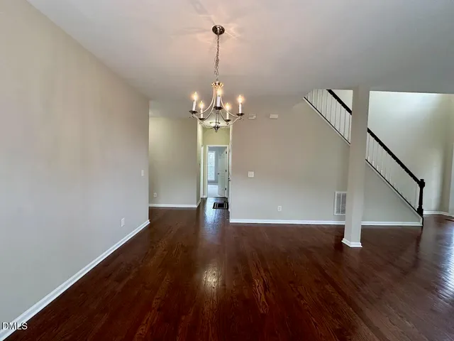 a view of a room with wooden floor and staircase