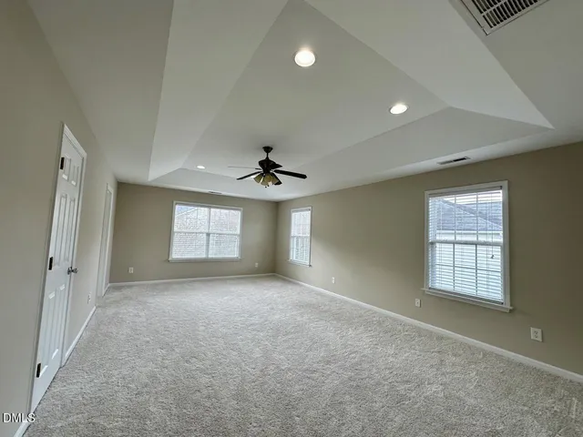 a view of an empty room with a ceiling fan