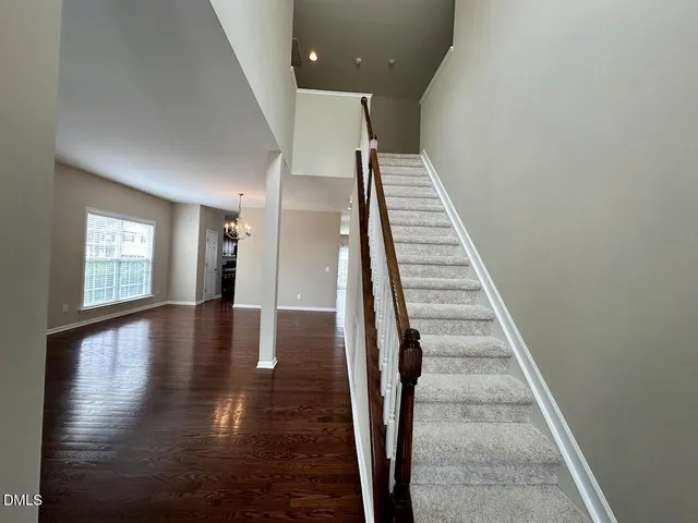 a view of entryway and hall with wooden floor