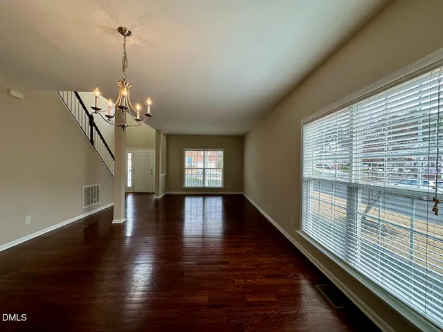 a view of a room with wooden floor