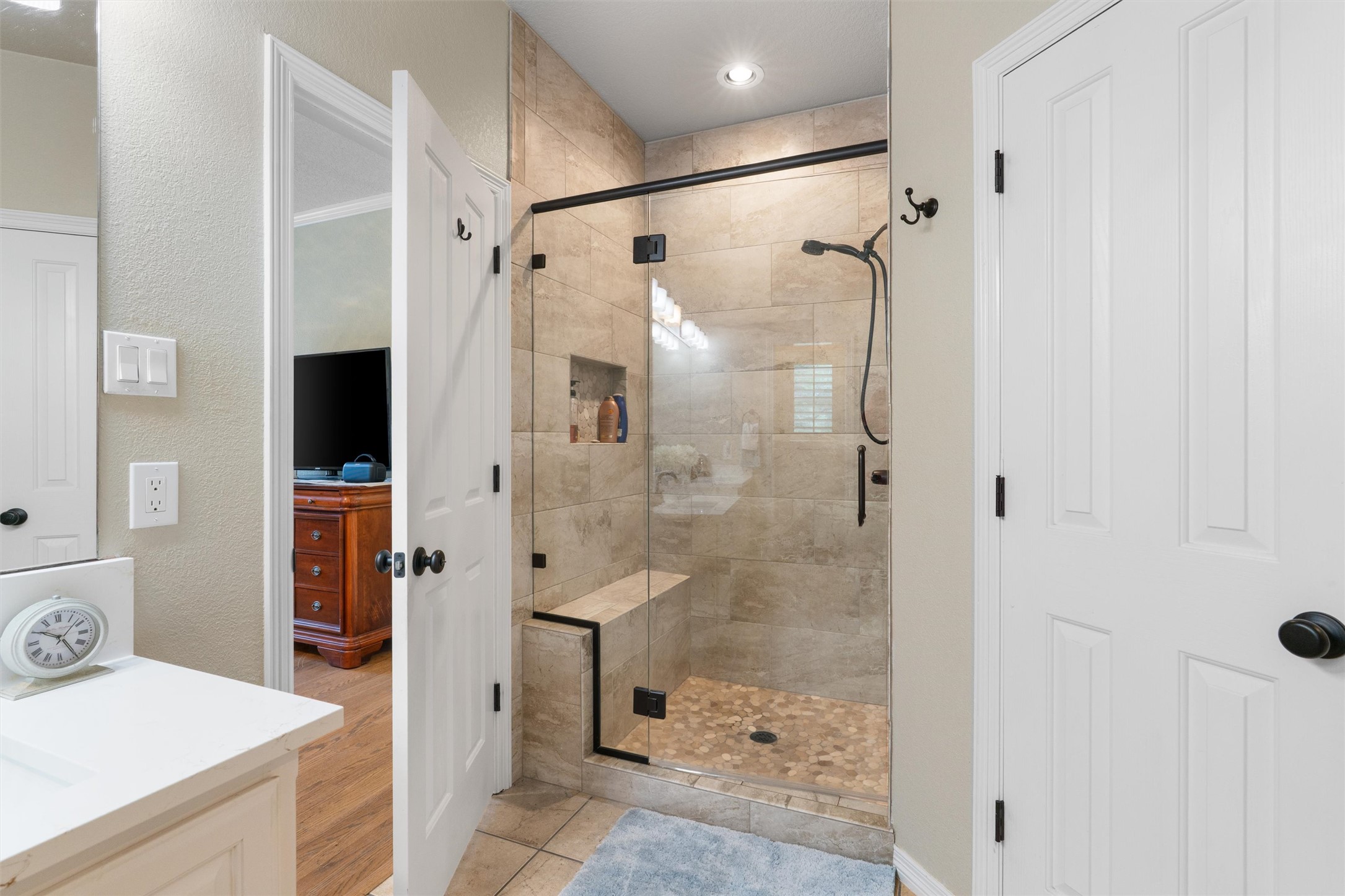 223 East Ridgewood Road Georgetown, TX 78633 - Photo 16 of 40 A gorgeous walk in shower features tile walls and a built-in bench in the primary bathroom
