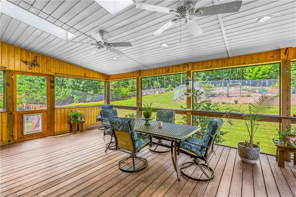 246 Bear Trail Lowgap, NC 27024 - Photo 14 of 50 Screened-in back porch with skylights and view of garden area.