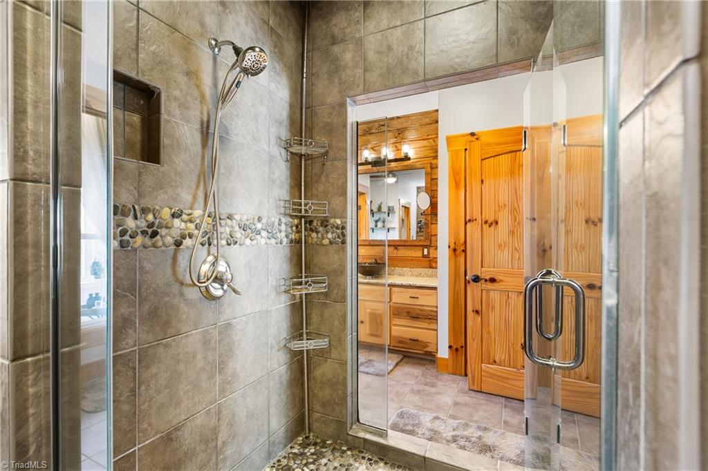 246 Bear Trail Lowgap, NC 27024 - Photo 16 of 50 Large tile shower in primary bath with entrance from both sides.