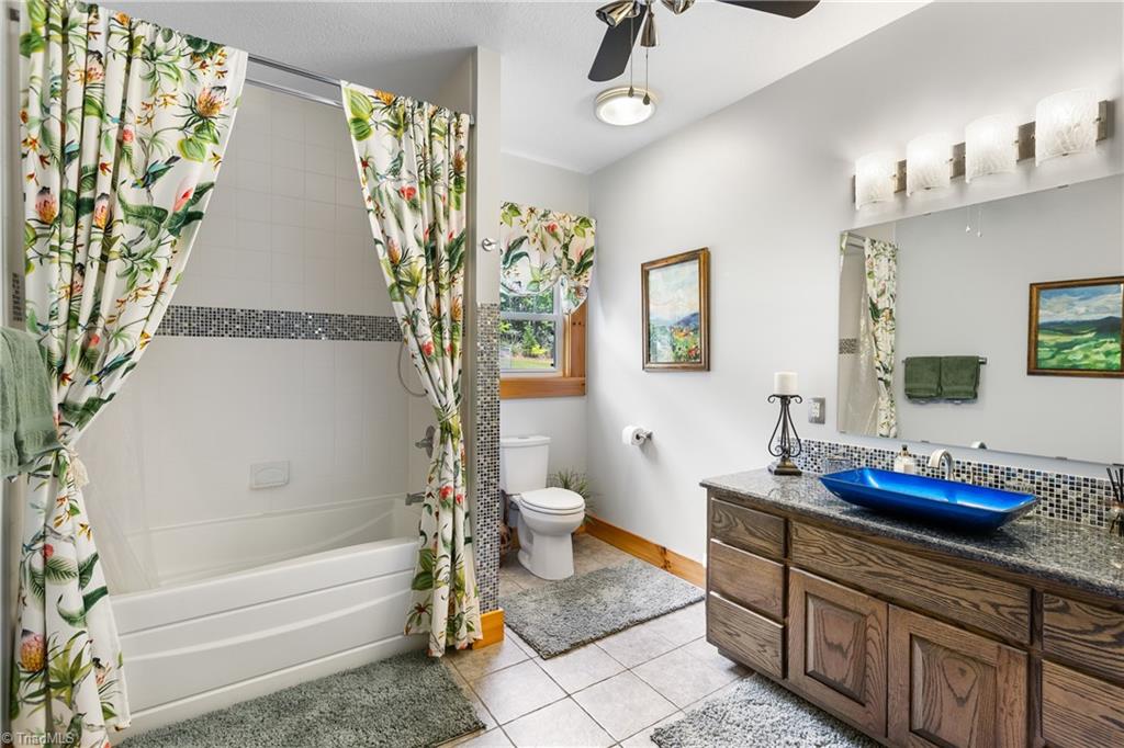 246 Bear Trail Lowgap, NC 27024 - Photo 19 of 50 Hall bathroom main level with tile tub surround.