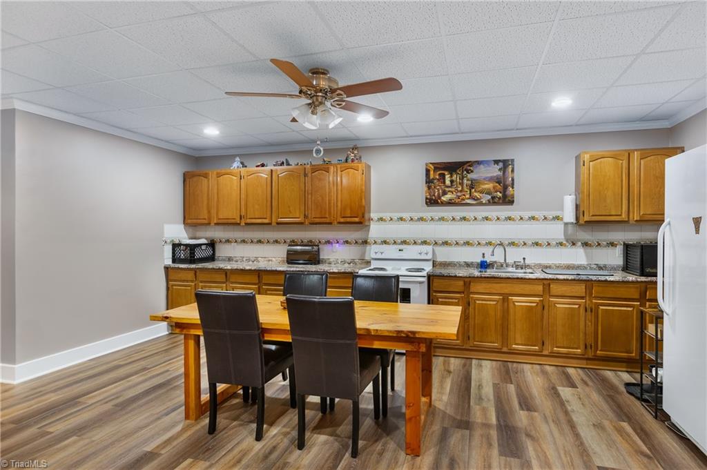 246 Bear Trail Lowgap, NC 27024 - Photo 22 of 50 Basement eat-in kitchen with stove and freezer. Tile backsplash.