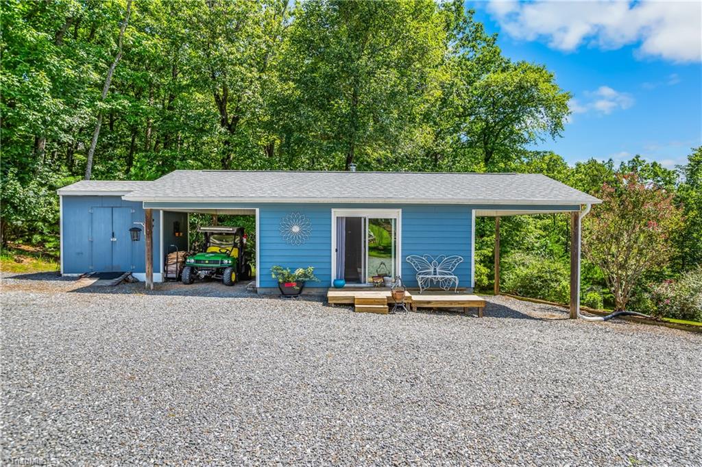 246 Bear Trail Lowgap, NC 27024 - Photo 26 of 50 Studio building with wood stove and carport on each side. Storage building on the left.