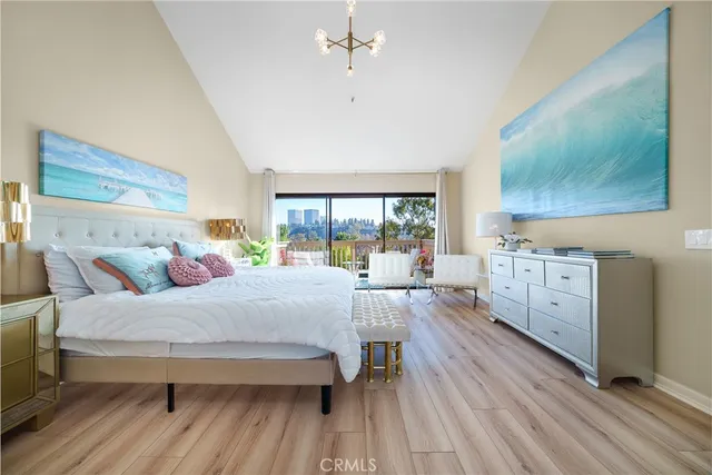 a spacious bedroom with a bed and a dresser next to a window