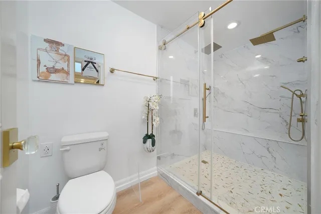 a white toilet sitting next to a bath tub shower