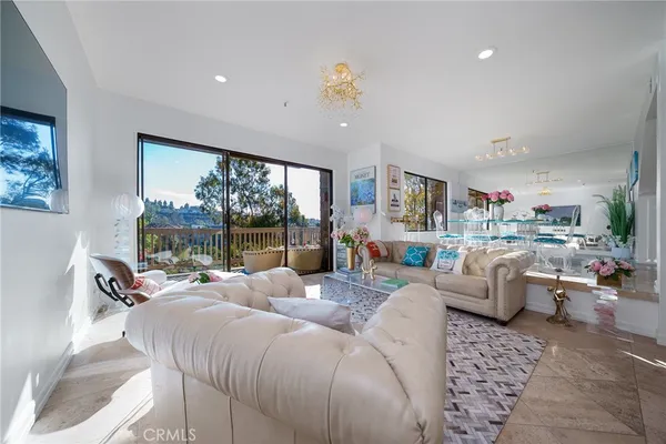 a living room with furniture large window and outer view