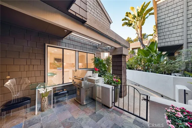 a view of a patio with table and chairs and potted plants