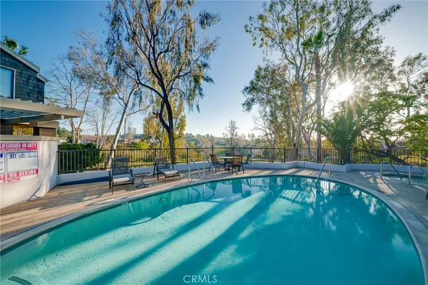 a swimming pool with outdoor seating and yard