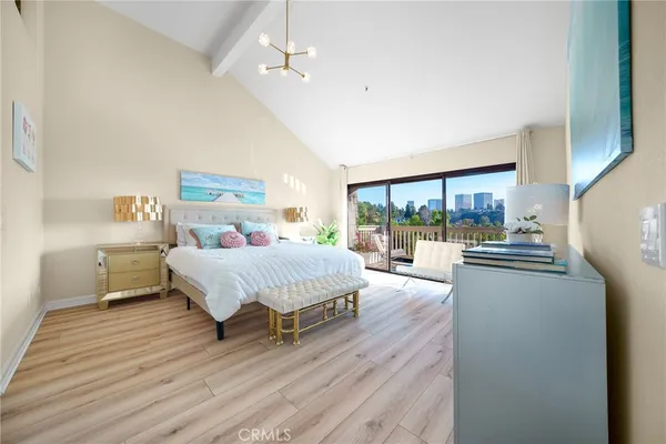 a spacious bedroom with a bed and a large window