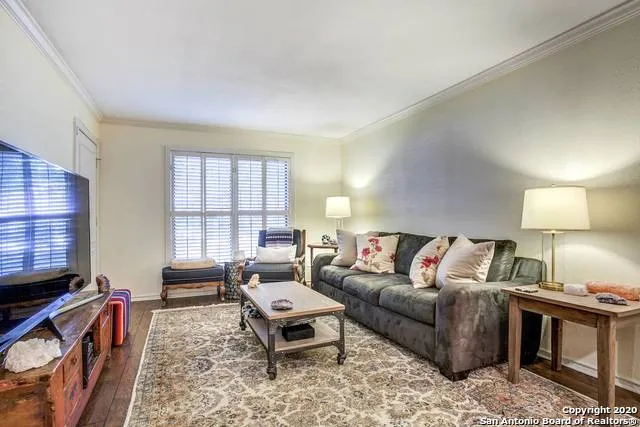 a living room with furniture a rug and a window