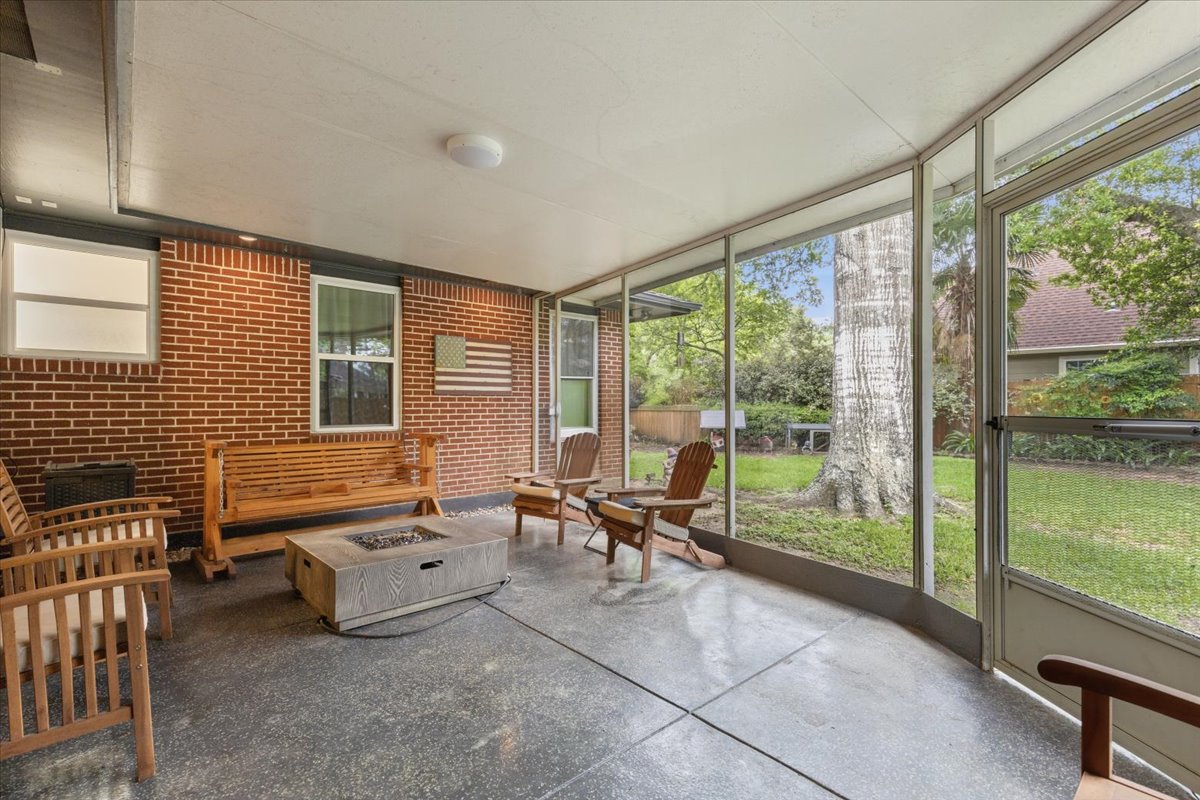 607 Short Street Smithville, TX 78957 - Photo 31 of 31 Spacious screened porch featuring concrete flooring and a full brick wall
