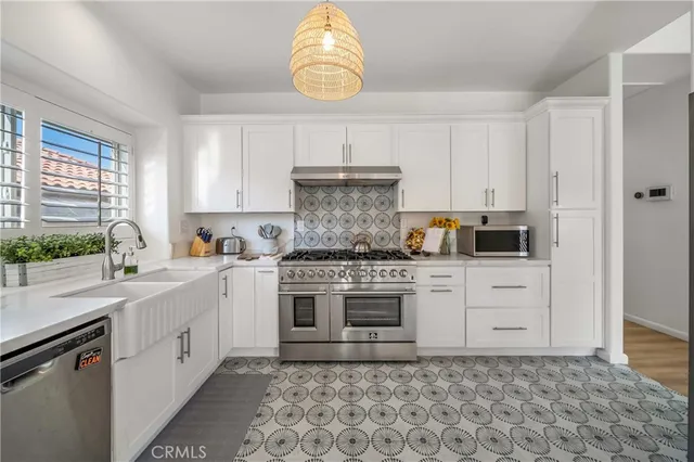 a kitchen with a stove oven and sink