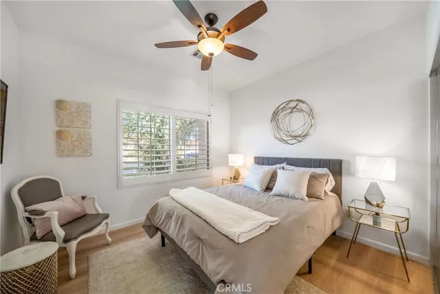 a bedroom with bed and a large window