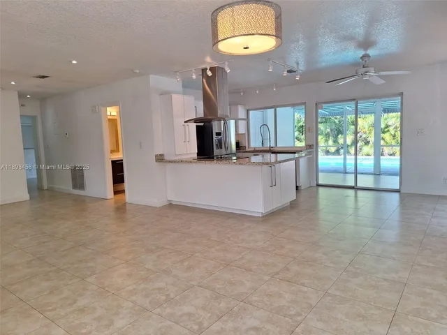 a view of a kitchen with a sink and a large window