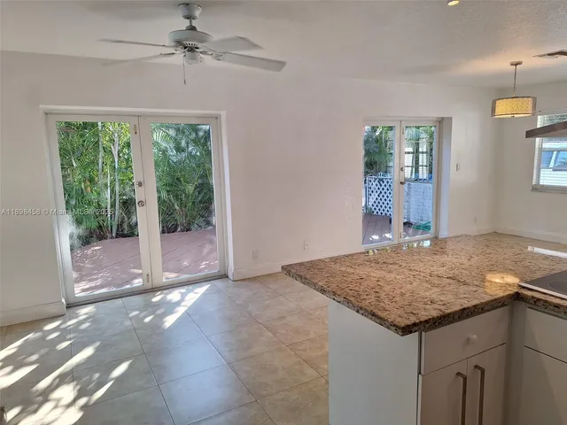 a view of livingroom with kitchen view and wooden floor