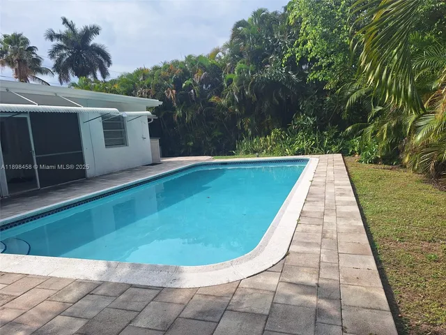 a view of swimming pool with a yard