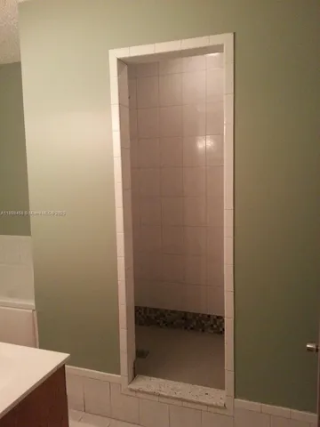 a bathroom with a glass shower door