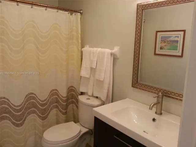 a bathroom with a toilet a sink and a mirror
