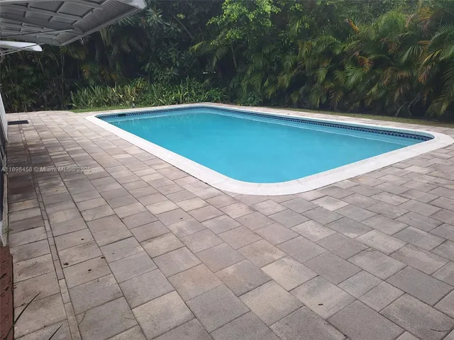 a view of an outdoor dining space with a table and chairs