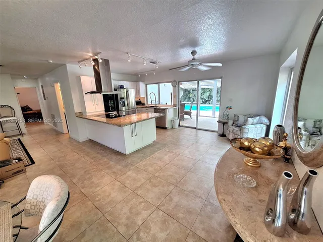 a living room with furniture a flat screen tv and a large window