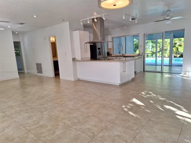 a view of a kitchen with a sink and a living room view