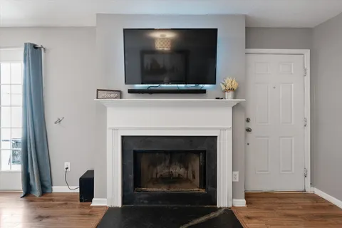 a living room with a fireplace and a flat screen tv