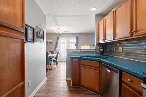 a kitchen with stainless steel appliances granite countertop a refrigerator and a stove top oven