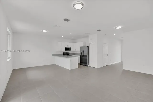 a kitchen with stainless steel appliances a refrigerator and a stove top oven
