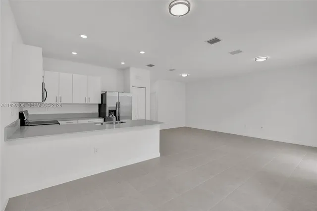 a view of a house with a wooden fence