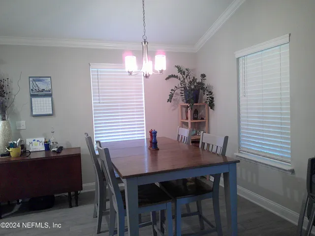 a dining room with a table and chairs