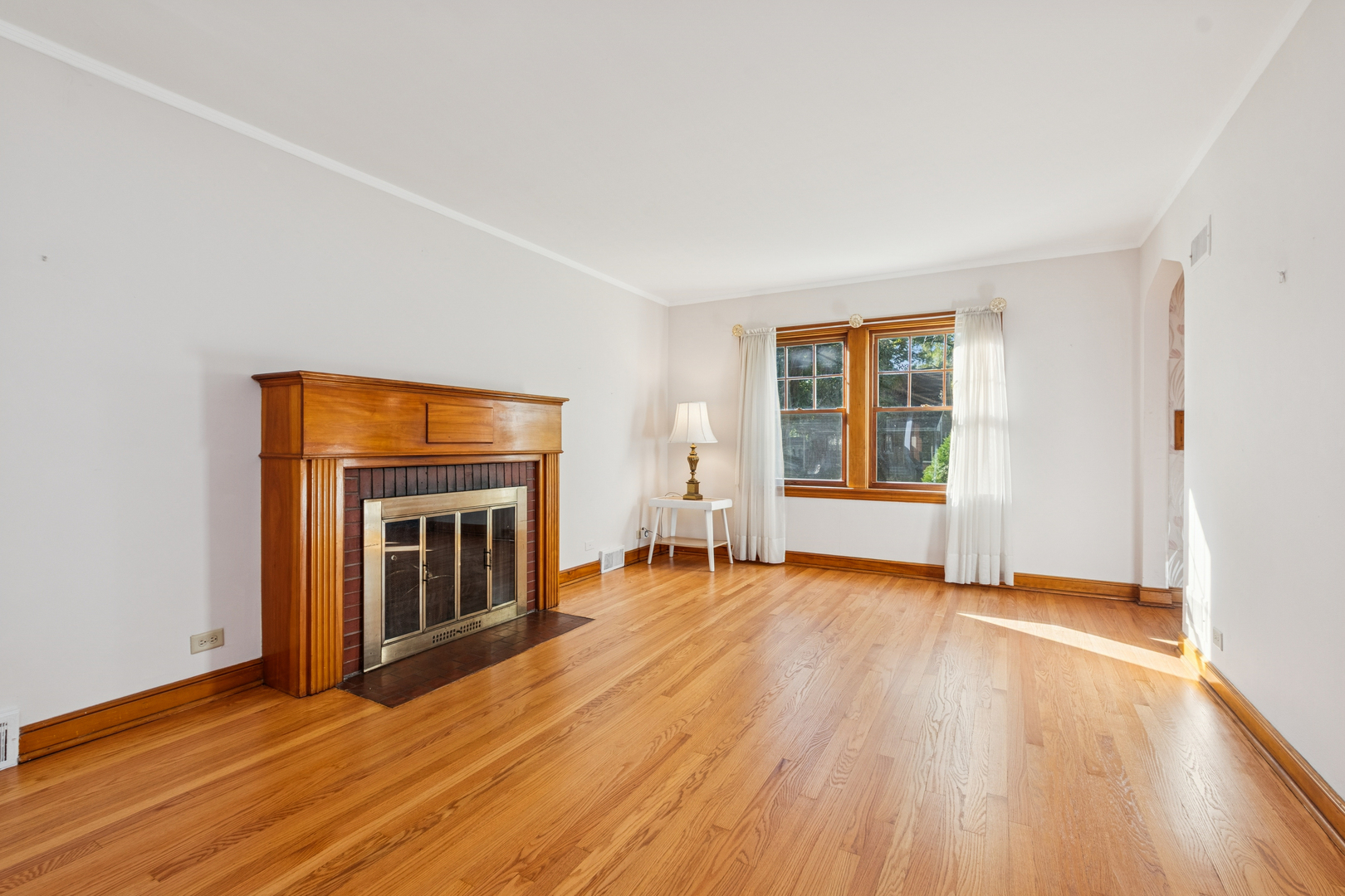 1850 Pine Road Homewood, IL 60430 - Photo 3 of 20 an empty room with wooden floor fireplace and windows