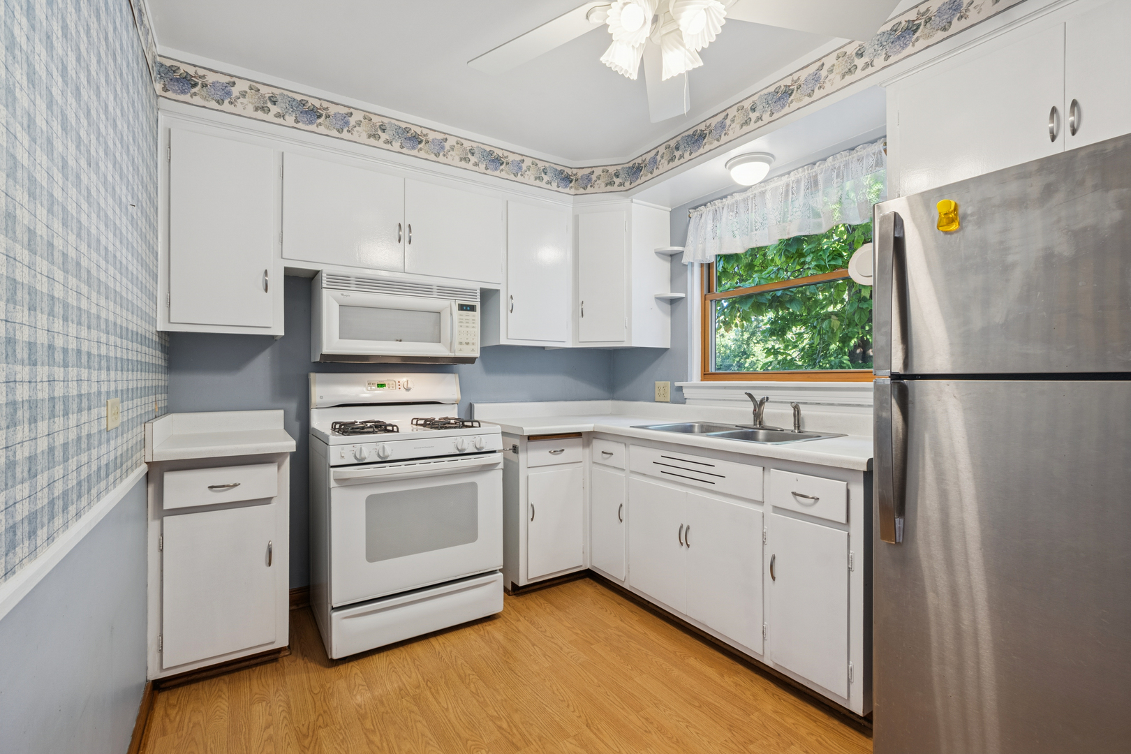 1850 Pine Road Homewood, IL 60430 - Photo 6 of 20 a kitchen with white cabinets and white appliances