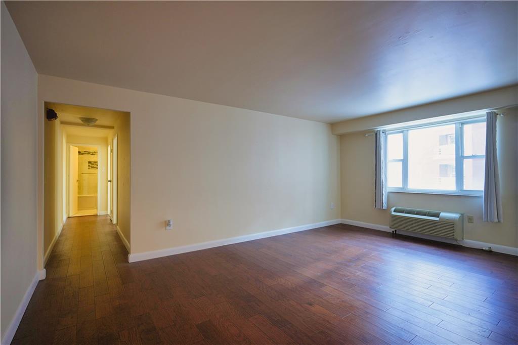 4625 Fifth Avenue, Unit 408 Pittsburgh, PA 15213 - Photo 13 of 34 an empty room with wooden floor and windows