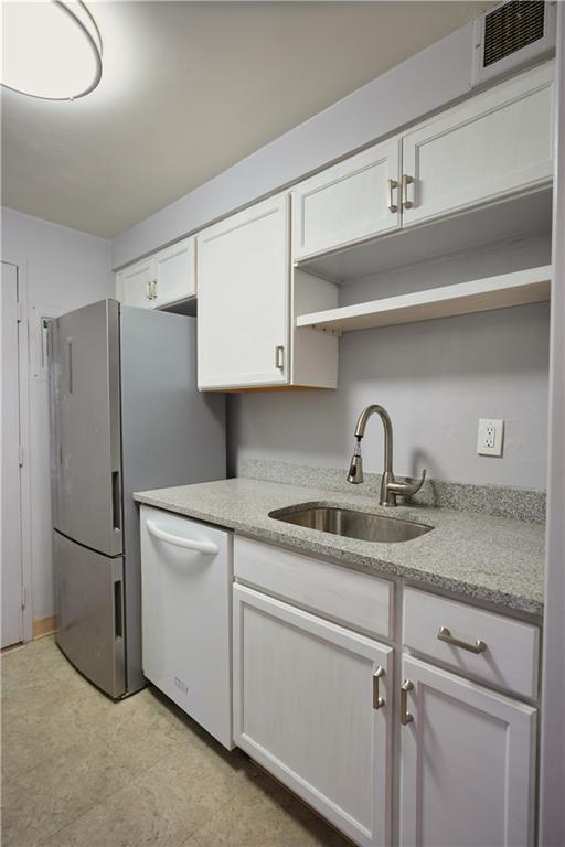 4625 Fifth Avenue, Unit 408 Pittsburgh, PA 15213 - Photo 14 of 34 a kitchen with stainless steel appliances granite countertop a sink and refrigerator