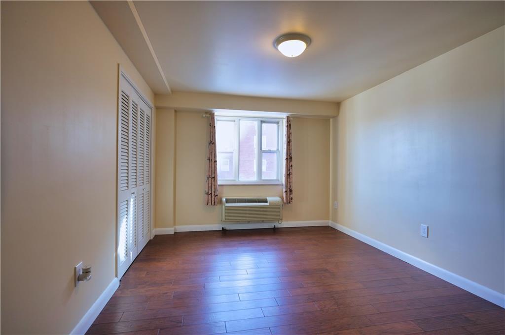 4625 Fifth Avenue, Unit 408 Pittsburgh, PA 15213 - Photo 17 of 34 an empty room with wooden floor and windows