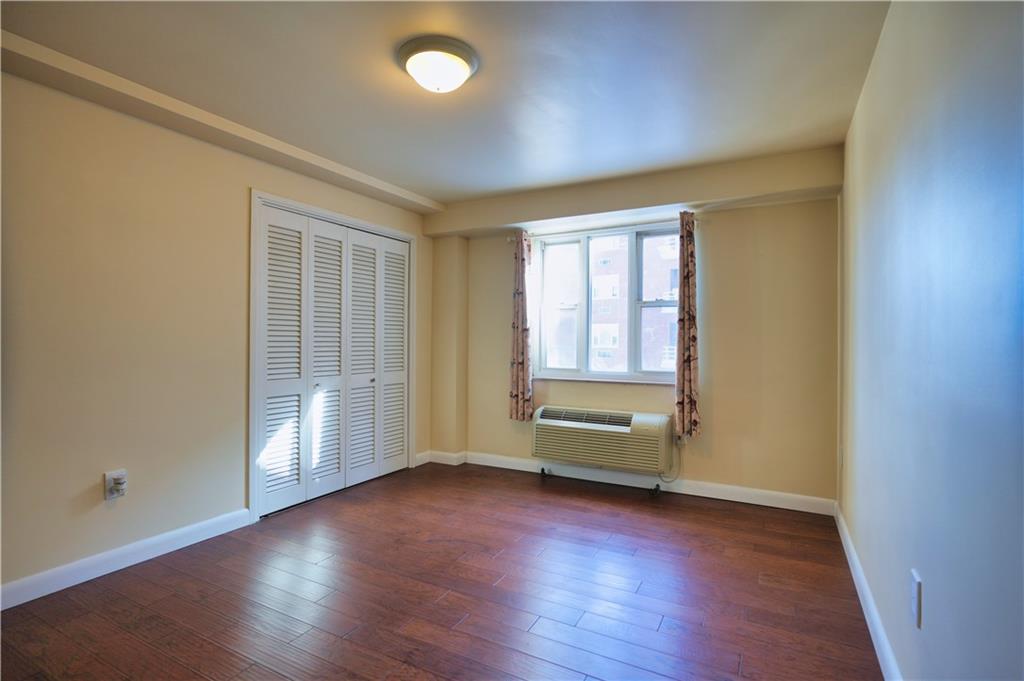 4625 Fifth Avenue, Unit 408 Pittsburgh, PA 15213 - Photo 18 of 34 an empty room with wooden floor and windows