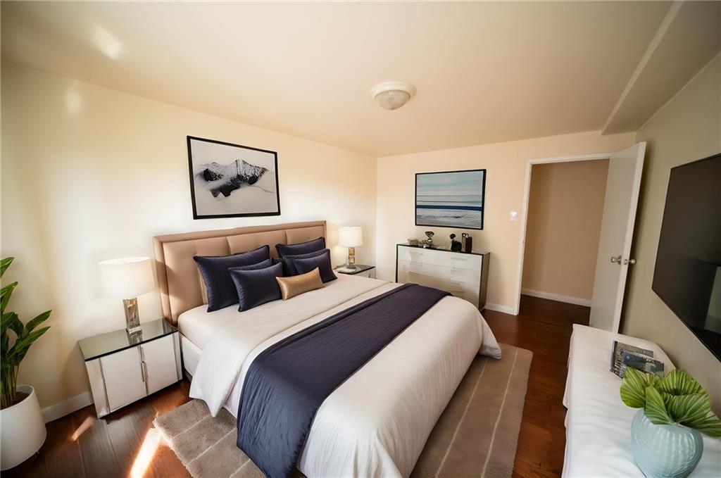 4625 Fifth Avenue, Unit 408 Pittsburgh, PA 15213 - Photo 26 of 34 a bed room with bed and a flat screen tv