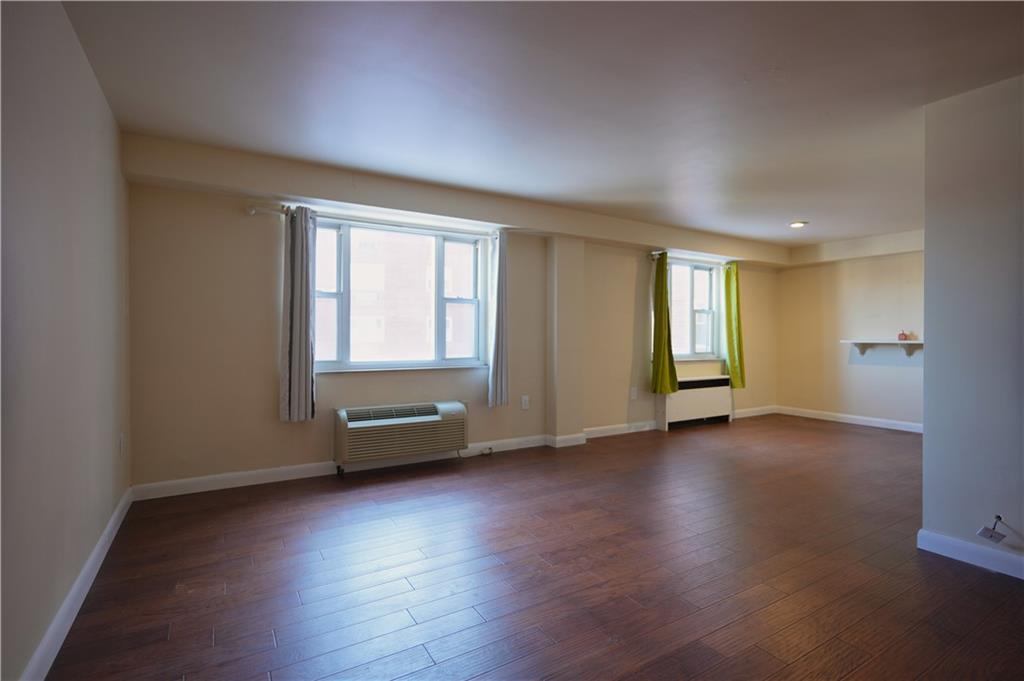 4625 Fifth Avenue, Unit 408 Pittsburgh, PA 15213 - Photo 9 of 34 an empty room with wooden floor and windows