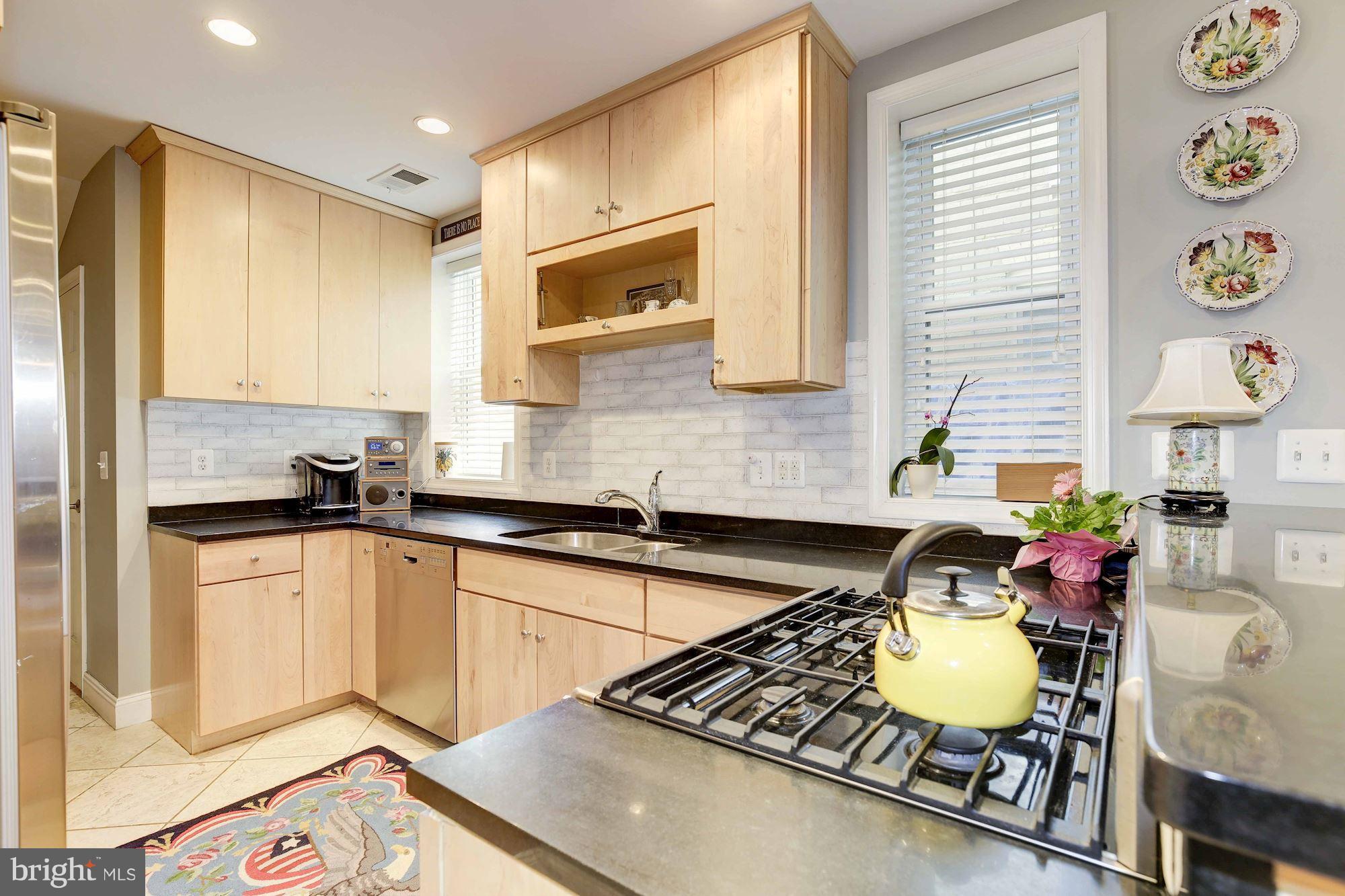 231 10th Street Northeast Washington, DC 20002 - Photo 6 of 17 a kitchen with a sink appliances and cabinets