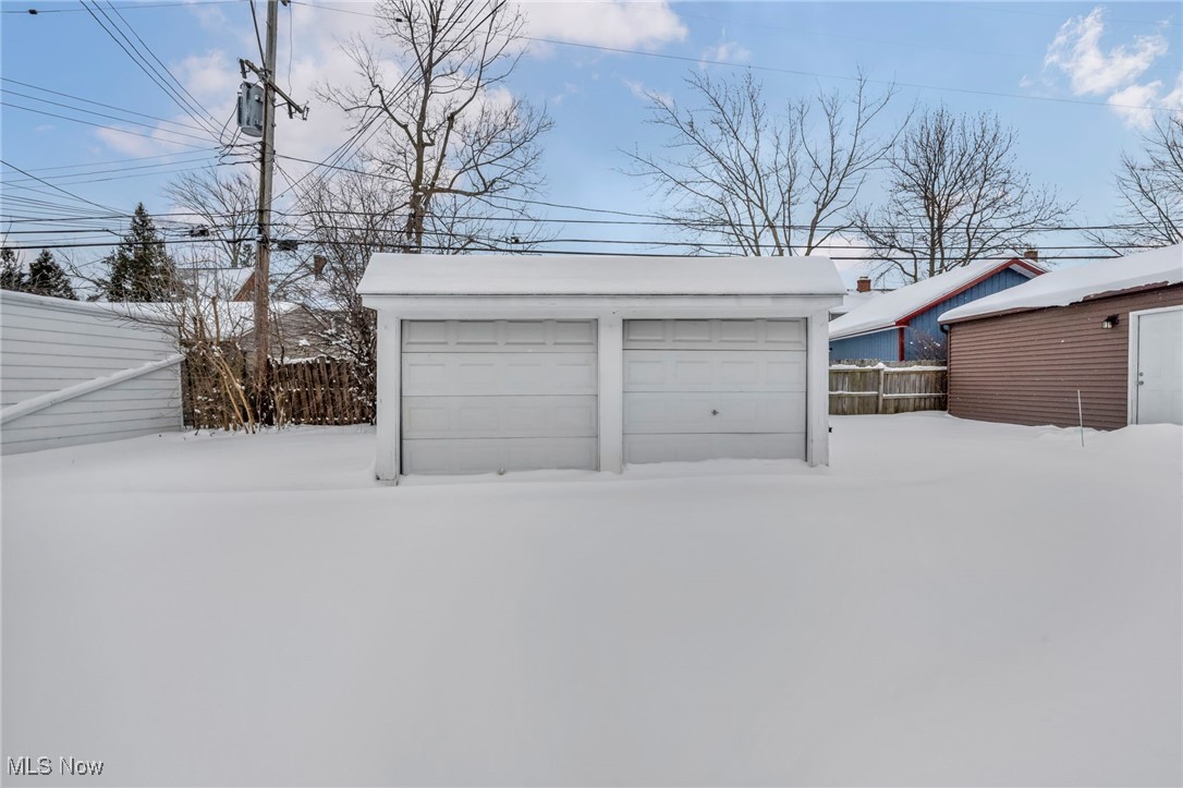 13614 Cedar Road Cleveland, OH 44118 - Photo 42 of 46 Snow covered garage with a detached garage and fence