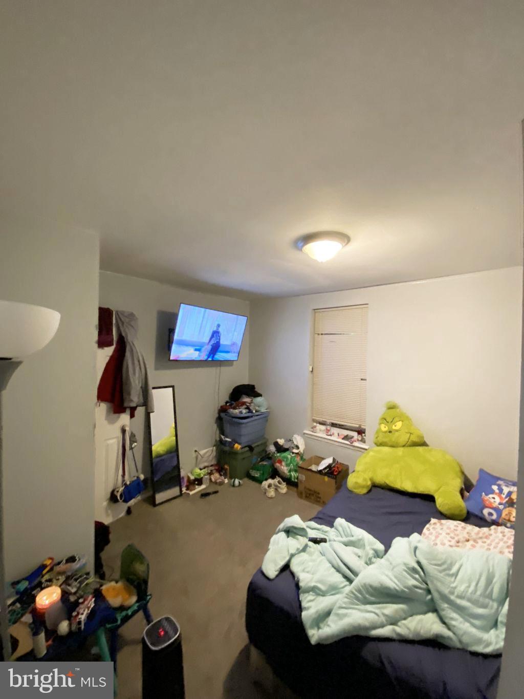 2845 Harlem Avenue Baltimore, MD 21216 - Photo 10 of 19 a bedroom with furniture and a lamp