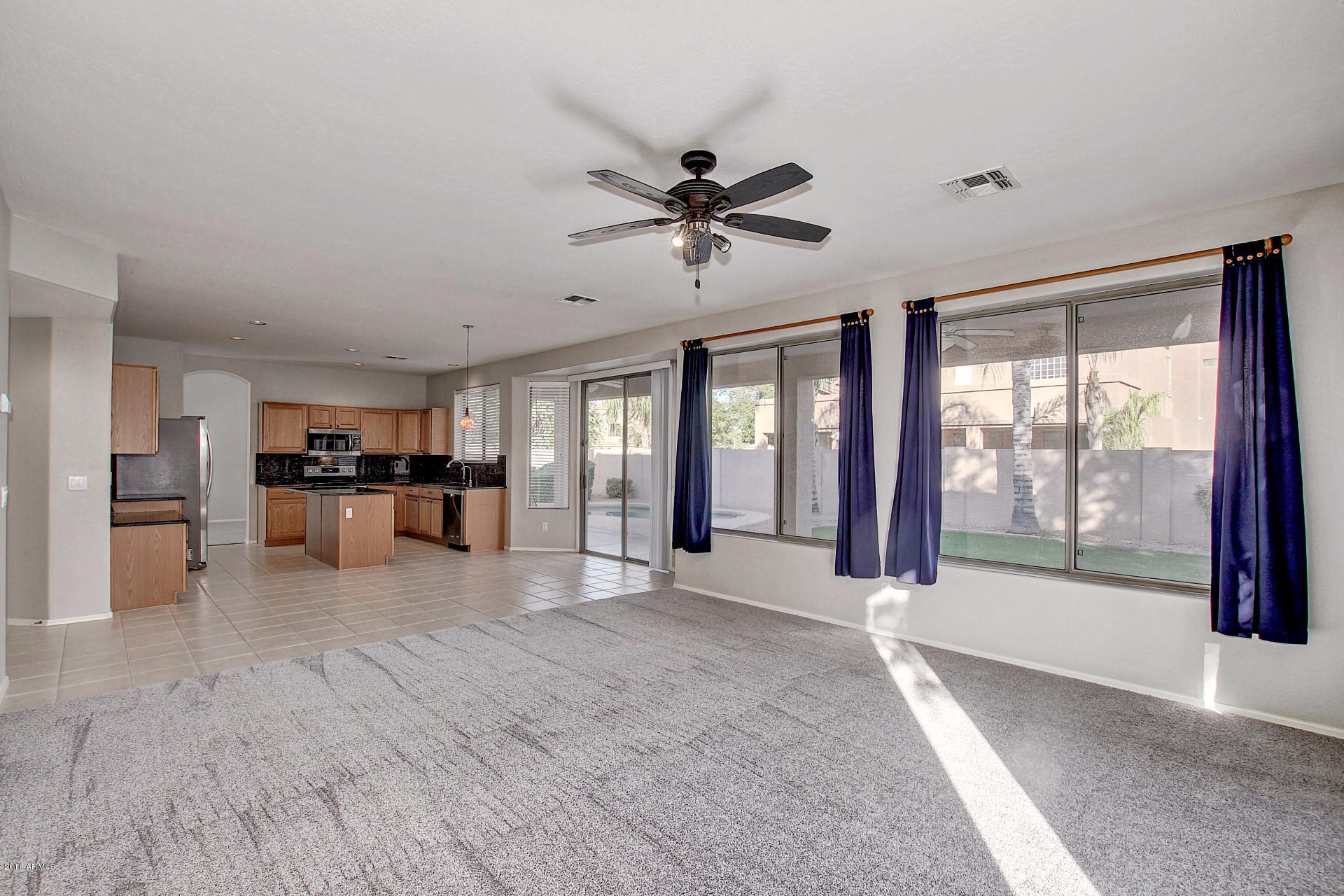1360 East Harrison Street Gilbert, AZ 85295 - Photo 10 of 34 a view of an empty room with a window and a kitchen