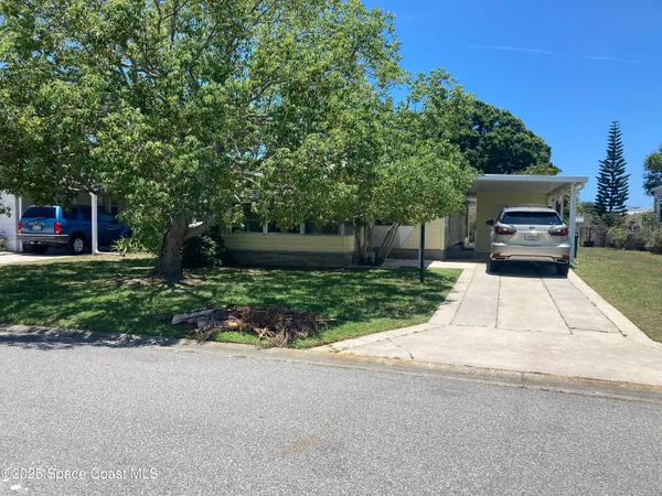 a view of house with outdoor space and parking